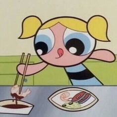 a cartoon character sitting at a table with chopsticks in front of her face