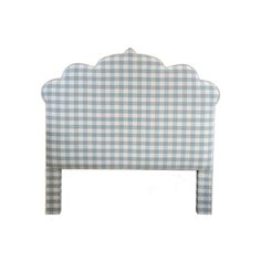 a blue and white checkered headboard with scalloped design on the top