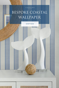 a white dresser with blue and white striped wallpaper in the background text reads bespoke coastal wallpaper shop now