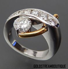 a diamond ring with three stones on it's sides and two diamonds in the middle