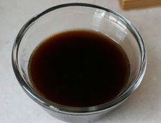 a glass filled with liquid sitting on top of a table