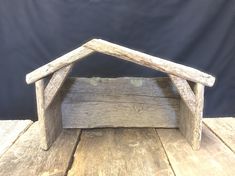 a small wooden structure sitting on top of a wooden floor