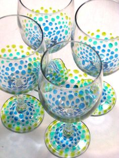 six wine glasses with blue and green dots on them