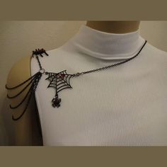 This Spider and Web Shoulder Chain was designed and created with cool black with red crystal metal spiders, black with red crystal metal webs, black chain, gunmetal jump rings and round clasps. The shoulder chain necklace has 4 stands of black cable chain draping in cascades down the upper arm from off the shoulder. There is one strand for the shoulder strap which continues around for the arm hole. The Shoulder Chain Necklace is made to be worn on either the right or the left side. You can also Shoulder Necklaces, Shoulder Jewelry, Shoulder Necklace, Short Sleeve Jacket, Shoulder Chain, Neck Chain, Crown Jewels, Black Chain, Red Crystals