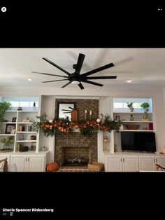 a living room with a fire place and a ceiling fan in it's center