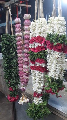 flowers are hanging from the side of a building