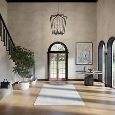 an elegant entryway with wood flooring and arched doorways