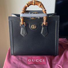 Gucci Diana Small Tote Bag. Double G. Black Leather. Shiny Antique Gold Toned Hardware. Comes With Two Decorative Belt Handle Shapers As Shown In The Pictures. Interior Open Pocket. Bamboo Handles With 2.6 Inch Drop. Web Strap Drop Is 16.5 Inches To 26.7 Inches And Leather Strap Drop Is 17.3 Inches To 21.6 Inches. Made In Italy. Comes With Dust Bag. I Have The Receipt That Shows The Purchase Price. Formal Black Shoulder Bag With Bamboo Handle, Luxury Formal Shoulder Bag With Bamboo Handle, Luxury Evening Bags With Bamboo Handle, Luxury Shopping Bag With Bamboo Handle, Luxury Evening Bag With Bamboo Handle, Luxury Shoulder Bag With Bamboo Handle, Gucci Black Everyday Luxury Bags, Elegant Gucci Bag With Top Carry Handle, Elegant Gucci Bag With Double Handle