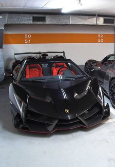 two black sports cars parked in a parking garage