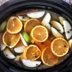 sliced oranges and apples are in an air fryer