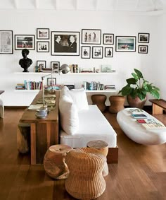 a living room filled with furniture and pictures on the wall