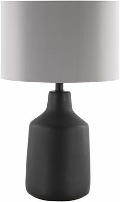 a black table lamp with a white shade on it's base and a gray drum light