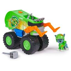 a green and orange toy truck next to a small figure