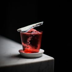 a small glass filled with liquid on top of a table