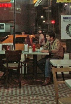 two men sitting at a table in a restaurant