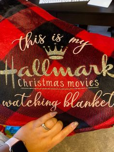 someone is holding up a christmas pillow that says, this is my haemark christmas movies watching blanket