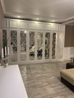 a living room filled with furniture and lots of glass doors leading to a bedroom area