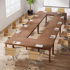 an empty conference room with wooden tables and chairs