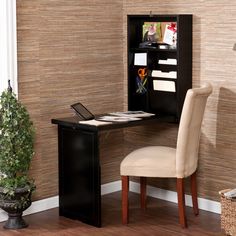 a wooden desk with a laptop computer on it and a chair in front of it