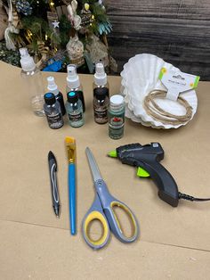 some crafting supplies are sitting on a table next to a christmas ornament