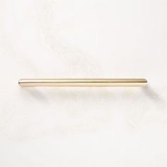 a gold colored handle on a white wall