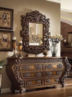 an ornate wooden dresser and mirror in a living room