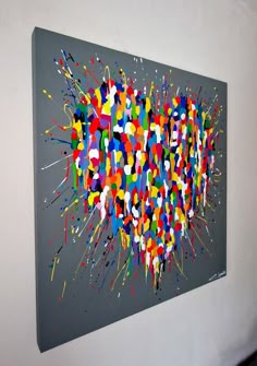 an abstract painting is displayed on the wall