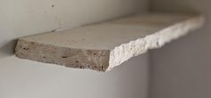 a stone shelf hanging on the wall