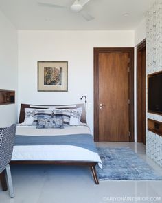 a bedroom with white walls and blue accents