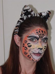 a woman with her face painted like a cat