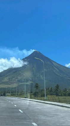 a large mountain towering over a city on a clear day