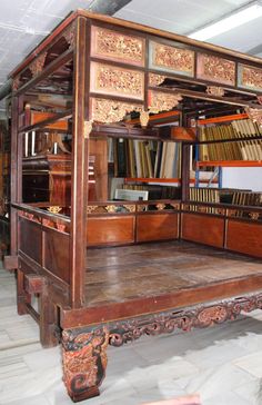 an old wooden book shelf with many books on it's sides and shelves full of books