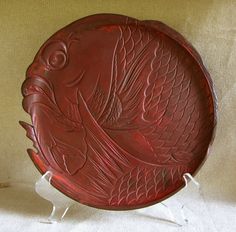 a red plate sitting on top of a white table