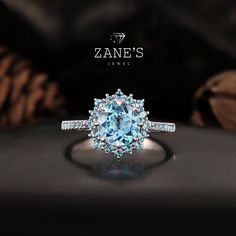 Elevate your jewelry collection with this stunning Sky Blue Topaz Halo Ring, designed for those who appreciate the finest craftsmanship and a touch of vintage elegance. Featuring a mesmerizing 1.5ct Sky Blue Topaz as the centerpiece, this ring is an embodiment of serene beauty and sophistication. Surrounding the main stone is a brilliant halo of smaller topaz gems, adding extra sparkle and depth, while the band is embellished with additional topaz stones, creating a dazzling effect from every angle. The topaz, known for its gentle sky-blue hue, captures the calming essence of a clear summer morning, symbolizing tranquility and clarity. As the birthstone for November, this ring makes a meaningful gift for those born in that month or anyone seeking a statement piece that embodies serenity. W Blue Topaz Halo Ring, 14k White Gold Diamond Ring, Topaz Engagement Ring, Halo Setting, Vintage Elegance, Gold Diamond Ring, Sky Blue Topaz, November Birthstone, Topaz Stone