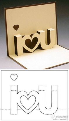 an open card with the word i love you cut out of paper and two hearts