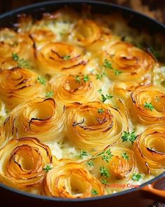 a pan filled with some food on top of a wooden table