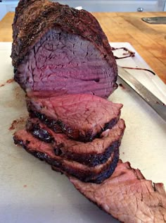 a large piece of meat sitting on top of a cutting board