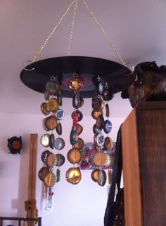 there are many different pieces of jewelry hanging from the ceiling in front of a dresser