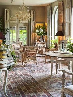 a living room filled with furniture and lots of windows