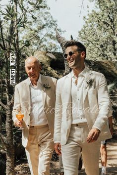 two men in white suits are walking together