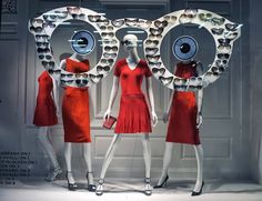 three mannequins dressed in red dresses with eyeballs on them