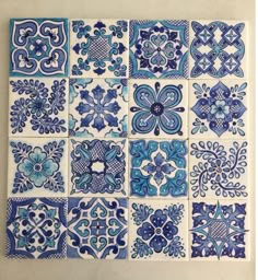 blue and white tiles with different designs on them