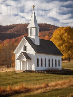 a white church with a cross on the roof and steeple is in an open field