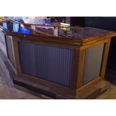 a large wooden bar sitting on top of a sidewalk