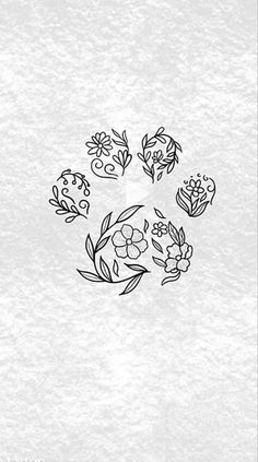 some flowers are arranged in the shape of a circle on a white paper with black ink