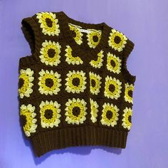 a brown sweater with yellow flowers on it