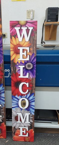 two wooden welcome signs with flowers on them