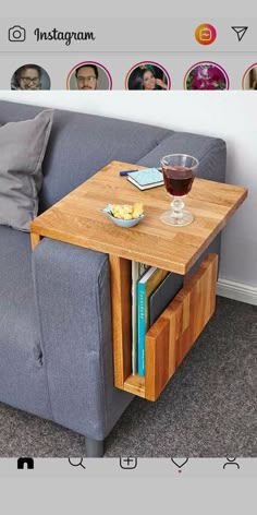 a couch with a wooden table on top of it next to a glass of wine