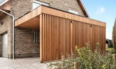 a brick building with wooden slats on the side