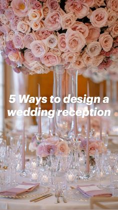 a tall vase filled with lots of pink flowers sitting on top of a white table